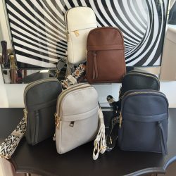 Sling bag with wide decorative adjustable strap